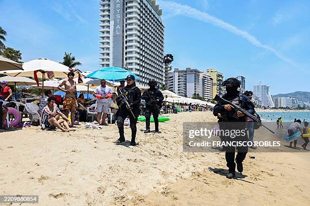 State police officers patrol a beach as part of a security operation to prevent criminal acts in the face of a wave of violence and protect tourists...