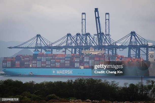 Maersk container ship is docked at the Yantian International Container Terminal, with multiple gantry cranes positioned for cargo handling, on April...