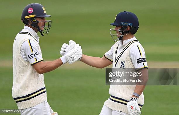 Warwickshire batsman Kai Smith reaches his 50 and is congratulated by Michael Booth during day two of the Rothesay County Championship Division One...