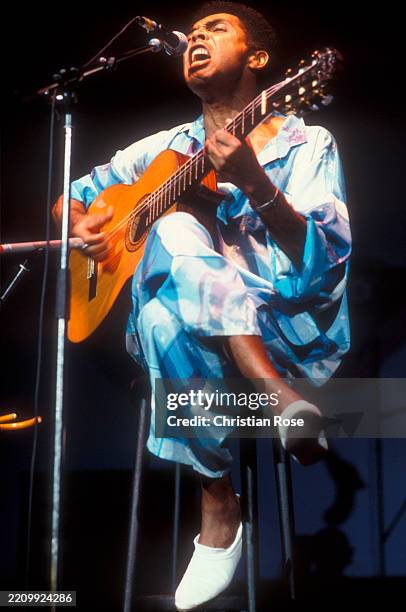 Gilberto Gil , Brazilian singer and guitarist, during a concert, July 1986.