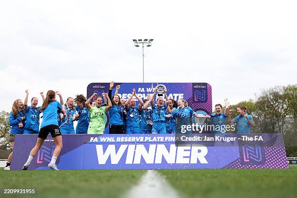 Players of Stockport County celebrates with the FA Women's National League Reserve Plate trophy after defeating Stoke City during the FA Women's...