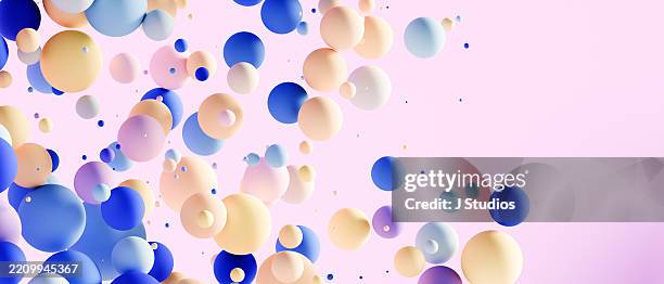 pastel horizon: panoramic display of floating spheres in soft blue, pink, yellow, and white - abundance stock pictures, royalty-free photos & images
