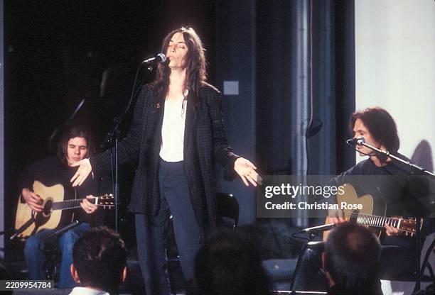 Patti Smith , American singer and guitarist, during a concert, 1996.