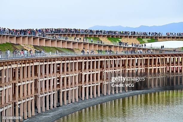 People visit the Grand Roof , the symbol of the venue, during the opening day of the World Expo 2025 Osaka at Yumeshima on April 13, 2025 in Osaka,...