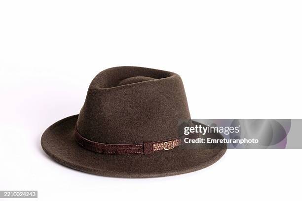 high angle view of a dark khaki fedora hat against white background. - trilby stock pictures, royalty-free photos & images