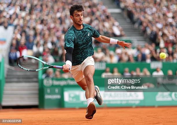 Lorenzo Musetti of Italy plays a return shot during the final of the singles between Carlos Alcaraz of Spain and Lorenzo Musetti of Italy during day...