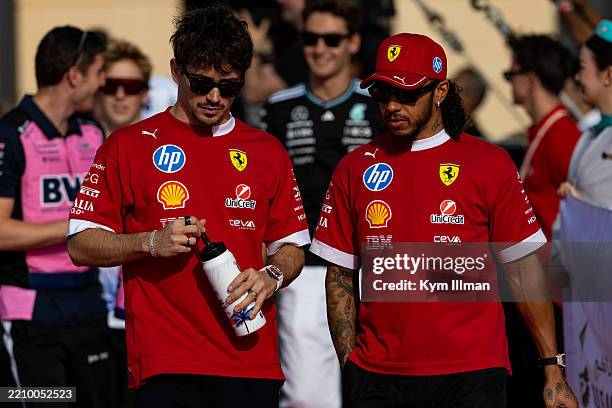 Charles Leclerc of Monaco and Ferrari walks to the Drivers' Parade with Lewis Hamilton of Great Britain and Ferrari during the F1 Grand Prix of...