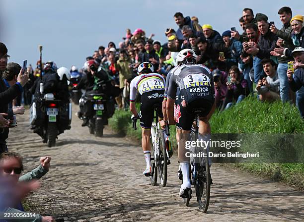 Tadej Pogacar of Slovenia and UAE Team Emirates - XRG and Jasper Philipsen of Belgium and Team Alpecin - Deceuninck compete in the breakaway passing...