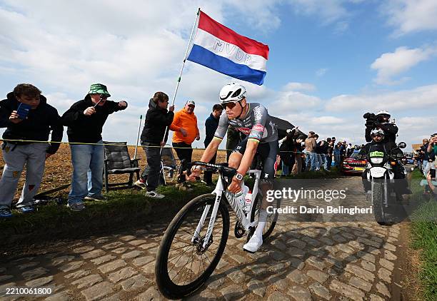 Mathieu Van Der Poel of Netherlands and Team Alpecin - Deceuninck competes in the breakaway passing through a cobblestones sector while fans cheer...