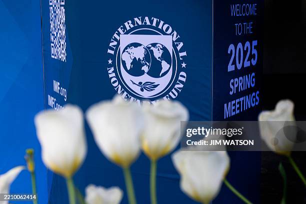 Sign advertising the International Monetary Fund/World Bank Spring Meetings is seen outside the IMF headquarters in Washington, DC, on April 17,...
