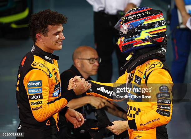 Third placed Lando Norris of Great Britain and McLaren and Race winner Oscar Piastri of Australia and McLaren congratulate each other in parc ferme...