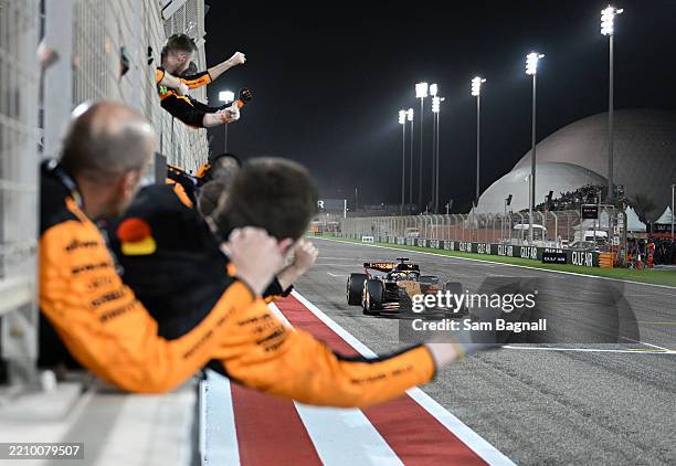 Race winner Oscar Piastri of Australia driving the McLaren MCL39 Mercedes crosses the line to cheers from his team on the pit wall during the F1...