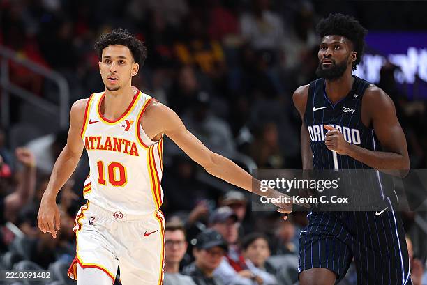 Zaccharie Risacher of the Atlanta Hawks reacts after hitting a three-point basket against Jonathan Isaac of the Orlando Magic during the first...