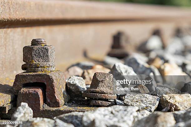 rusty screws on a railway track - train tracks end stock pictures, royalty-free photos & images