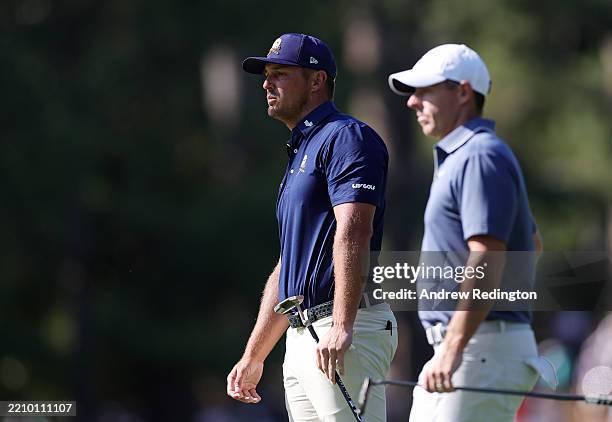 Bryson DeChambeau of the United States and Rory McIlroy of Northern Ireland wait on the tenth hole during the final round of the 2025 Masters...