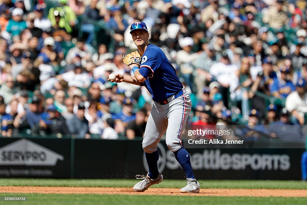 Seattle Rangers Josh Jung of the Texas Rangers throws to first base during the second ...