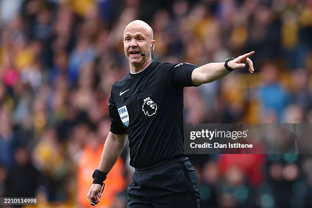 Referee Anthony Taylor gestures to the players during the Premier League match between Wolverhampton Wanderers FC and Tottenham Hotspur FC at...
