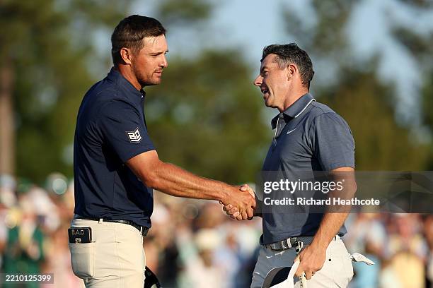 Rory McIlroy of Northern Ireland shakes hands with Bryson DeChambeau of the United States on the 18th hole during the final round of the 2025 Masters...