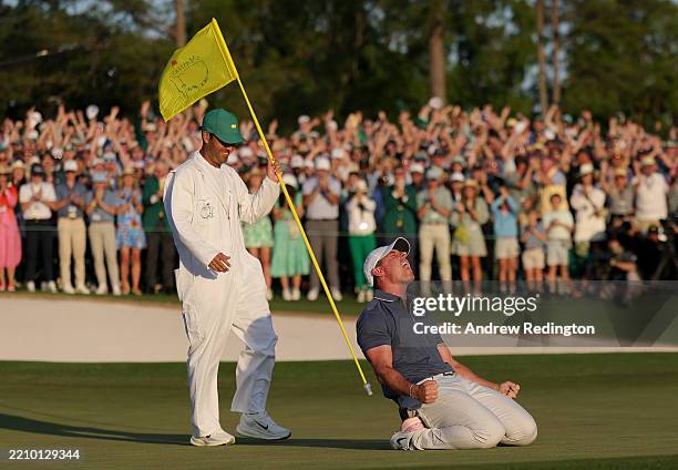Rory McIlroy of Northern Ireland celebrates winning with caddie Harry Diamond after the playoff hole during the final round of the 2025 Masters...