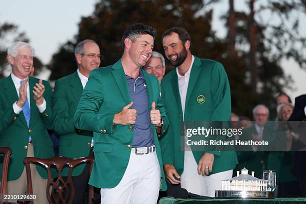 Rory McIlroy of Northern Ireland is awarded the Green Jacket by Masters Champion Scottie Scheffler after the final round of the 2025 Masters...