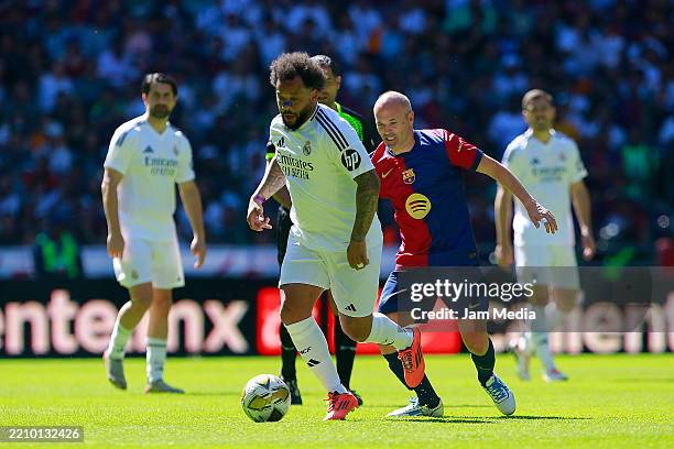 Marcelo of Real Madrid and Andres Iniesta of Barcelona compete for the ball during a friendly match between FC Barcelona Legends and Real Madrid CF...