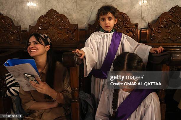 Palestinian Christians attend the Good Friday mass at the Greek Orthodox church of Saint Porphyrius in Gaza City on April 18, 2025.