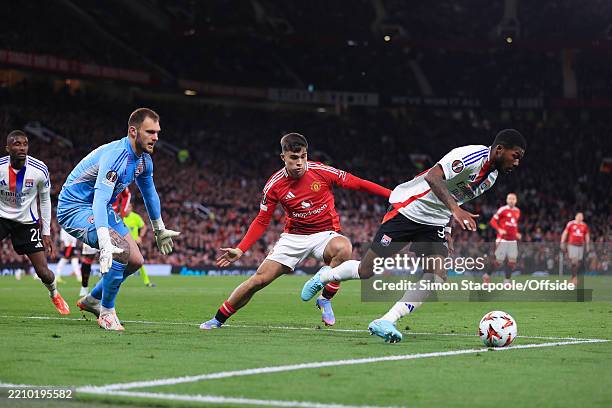 Harry Amass of Manchester United puts pressure on Olympique Lyonnais goalkeeper Lucas Perri and Ainsley Maitland-Niles of Olympique Lyonnais during...
