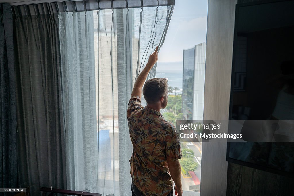 Window Lookout Man In Hotel Room Open Curtains And Lookout The Window High-Res Stock ...