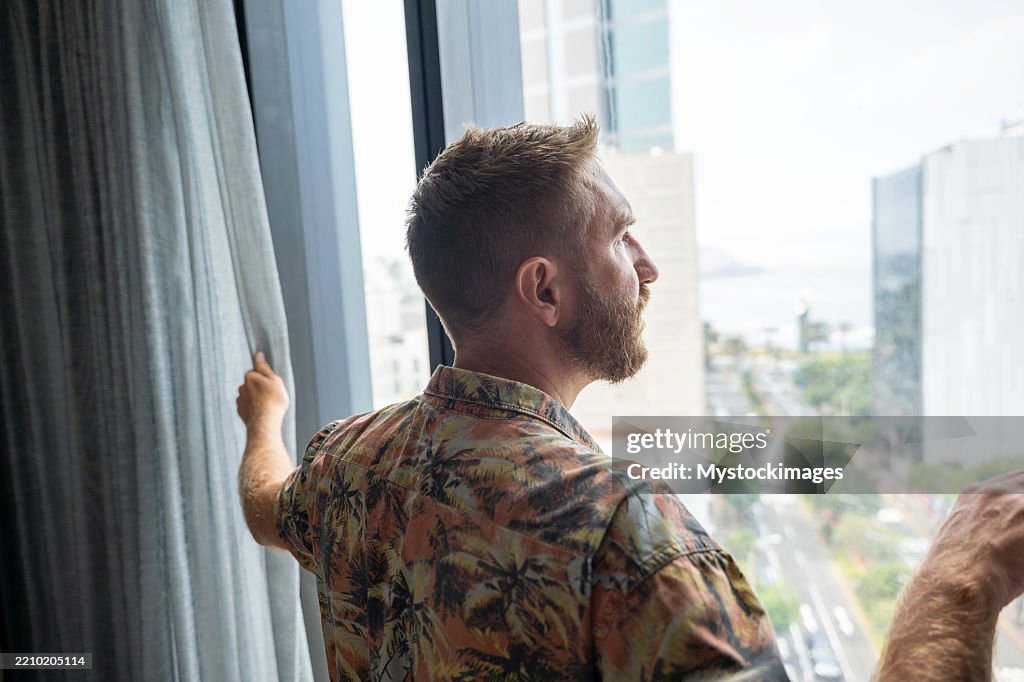 Window Lookout Man In Hotel Room Open Curtains And Lookout The Window High-Res Stock ...