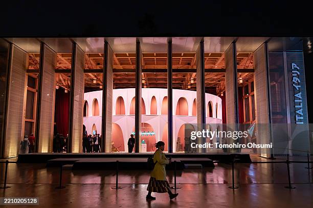 Woman walks past the Italy Pavilion as Milano Cortina Olympic and Paralympic torches are unveiled at the Expo 2025 Osaka Italy Pavillion on April 14,...