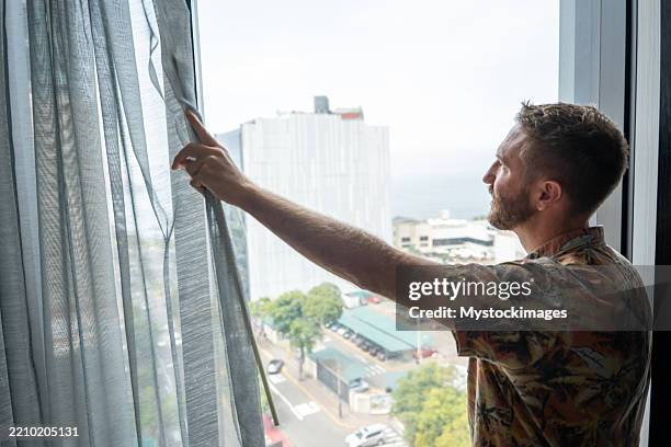 Window Lookout Man In Hotel Room Open Curtains And Lookout The Window High-Res Stock ...
