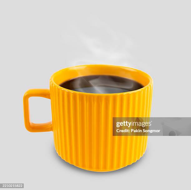 black coffee in yellow mug with smoke on grey background. - pires imagens e fotografias de stock
