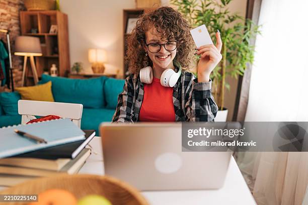 teenager doing online shopping with credit card at home - manufactured object stock pictures, royalty-free photos & images