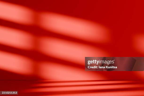 minimalist abstract 3d red background with shadows and diagonal light patterns on wall. modern empty room, geometric composition, simplicity. place for text, and designs. copy space. - studio lighting equipment stock pictures, royalty-free photos & images