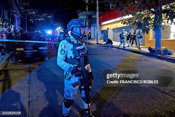 Police officer guards a crime scene at the corner of 9th Street and Ejido Avenue, where a man was shot in the Cuauhtémoc neighborhood in Acapulco,...