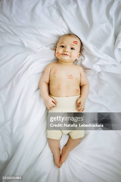 kissed with love: infant in soft wool diaper with red lipstick marks, eco-friendly care. - cloth nappy stock pictures, royalty-free photos & images