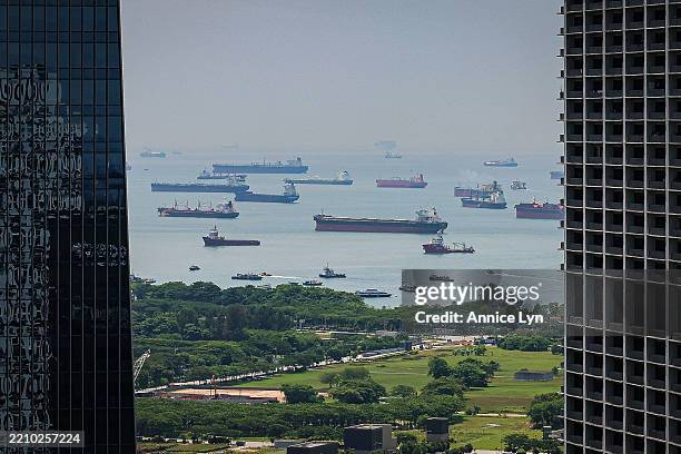 View of cargo ships in the Singapore Strait, framed between two high-rise buildings, on April 14 in Singapore. Singapore, one of the world's most...