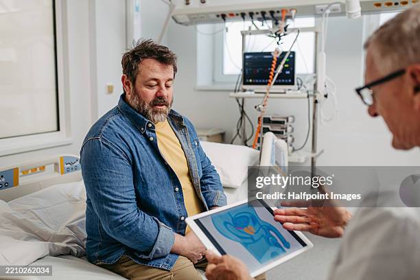 doctor explaining prostate examination to male patient. - sistema urinario fotografías e imágenes de stock