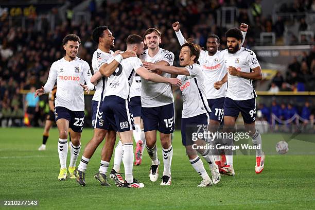 Matt Grimes of Coventry City celebrates his team's first goal with teammates, an own goal scored by Charlie Hughes during the Sky Bet Championship...