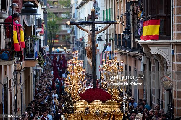 Float with a statue of Santisimo Cristo de los Favores of the Hermandad de los Favores procession moves through the crowd during the procession on...