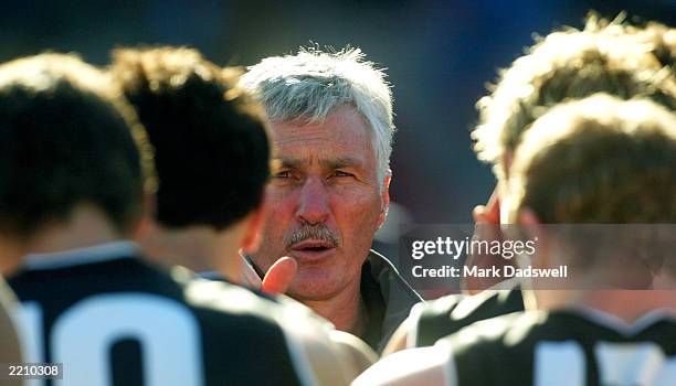 Michael Malthouse coach of the Magpies addresses his players during the round 17 AFL match between the Collingwood Magpies and the Carlton Blues at...