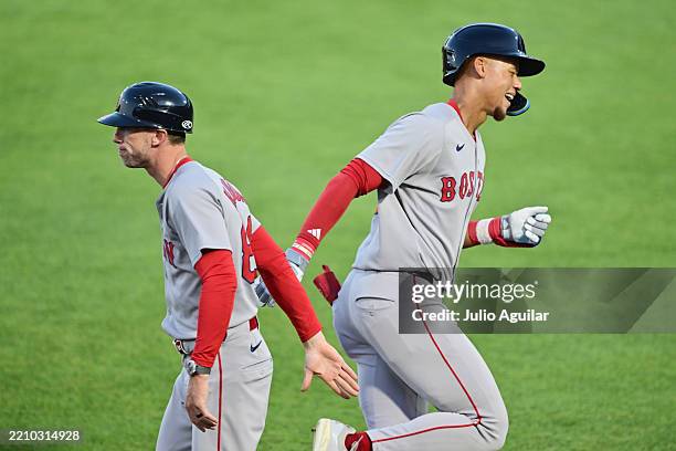 Kristian Campbell of the Boston Red Sox celebrates his solo home run with third base coach Kyle Hudson in the third inning against the Tampa Bay Rays...