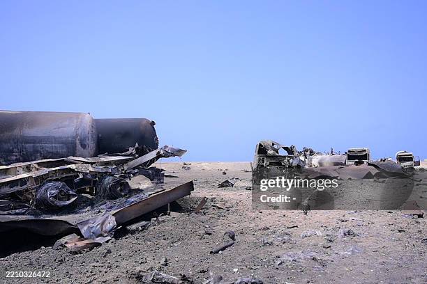 Burned vehicles lie near the port of Ras Issa in Yemen's Hodeida province following reorted US strikes, on April 18, 2025. The April 17 US strikes on...