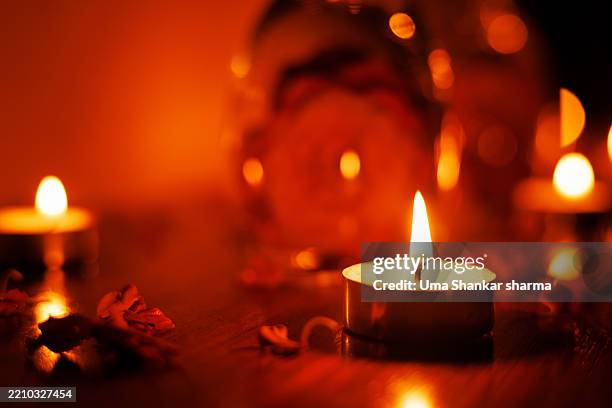 romantic candlelight with petals – warm ambient tealight setup - tealight stock pictures, royalty-free photos & images