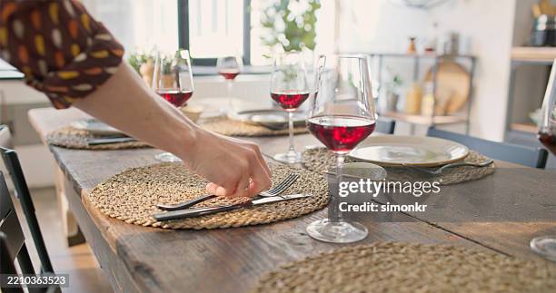 elegant dining table setup with wooden accents and red wine in bright home interior - dukning bildbanksfoton och bilder