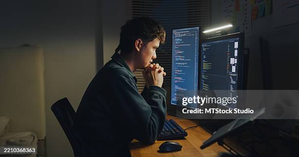 young man software engineer experience emotional stress while working late on ai prompt coding on computer in bedroom at home night. software developer, artificial intelligence and programmer. - python muster stock pictures, royalty-free photos & images