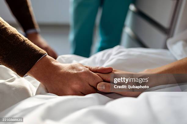 gentle hands of care and compassion in a medical environment - hand on shoulder stock pictures, royalty-free photos & images
