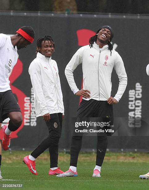 Rafael Leao and Samuel Chukwueze of AC Milan smile during AC Milan training session at Milanello on April 15, 2025 in Cairate, Italy.