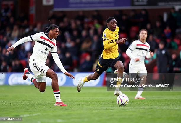 Dani Angel of Wolverhampton Wanderers is challenged during the Premier League 2 match between Wolverhampton Wanderers and Manchester United at...