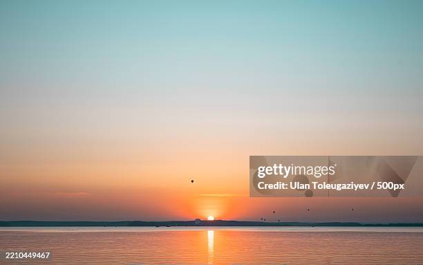 scenic view of sea against orange sky,belarus - belarus stock pictures, royalty-free photos & images